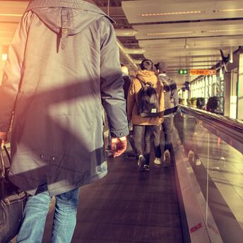 Passenger walking through an airport terminal with luggage