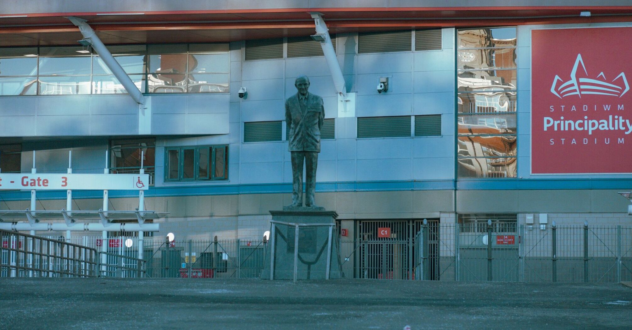 Statue in front of Principality Stadium, Cardiff Central Station visible behind