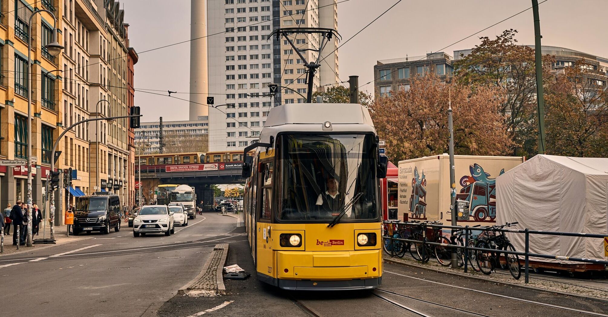 Tram in a city with TV tower in the background