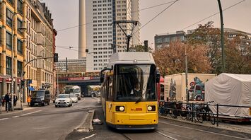 Tram in a city with TV tower in the background
