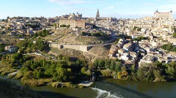Aerial view of Toledo, Spain, showing historic buildings and a river