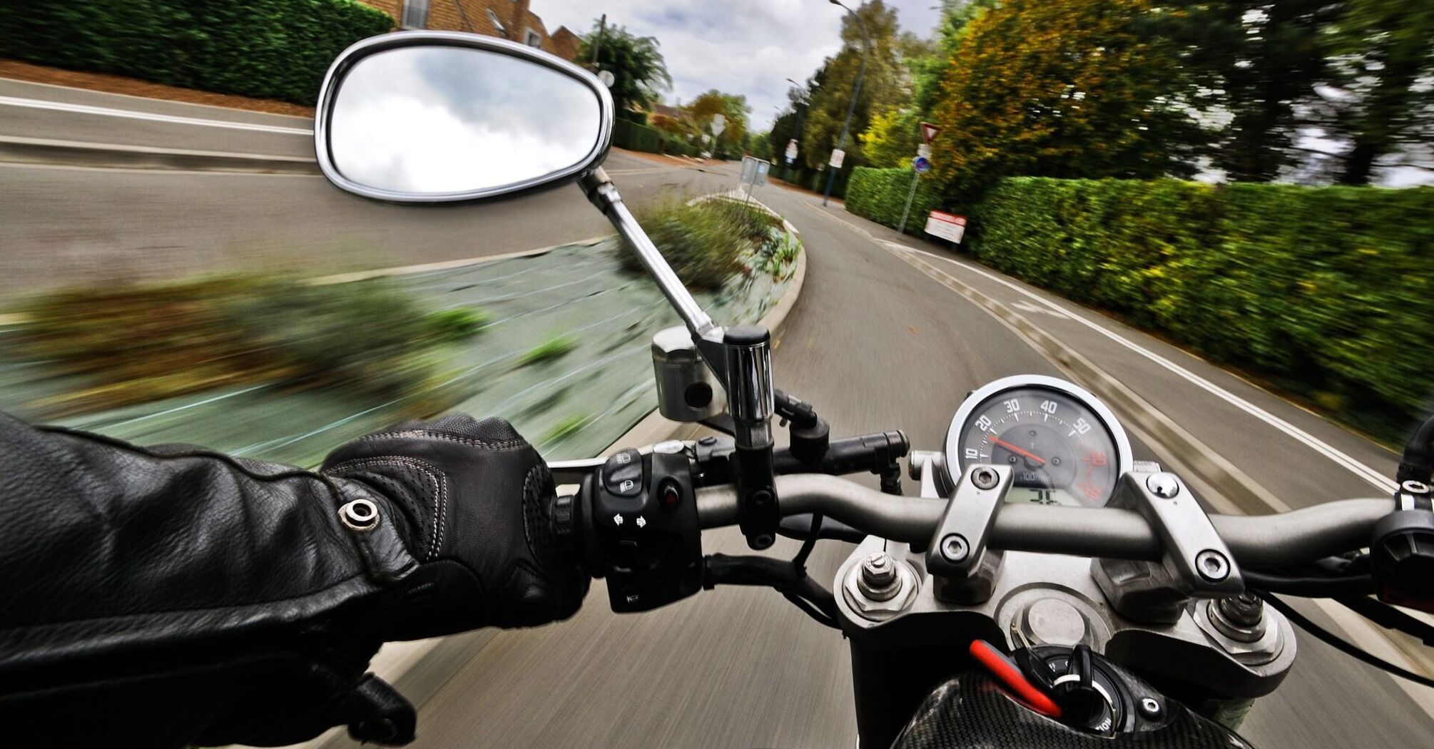 Motorcyclist riding through a residential street