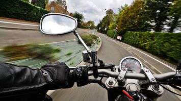 Motorcyclist riding through a residential street