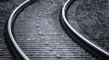 Curved railway tracks in a wooded area