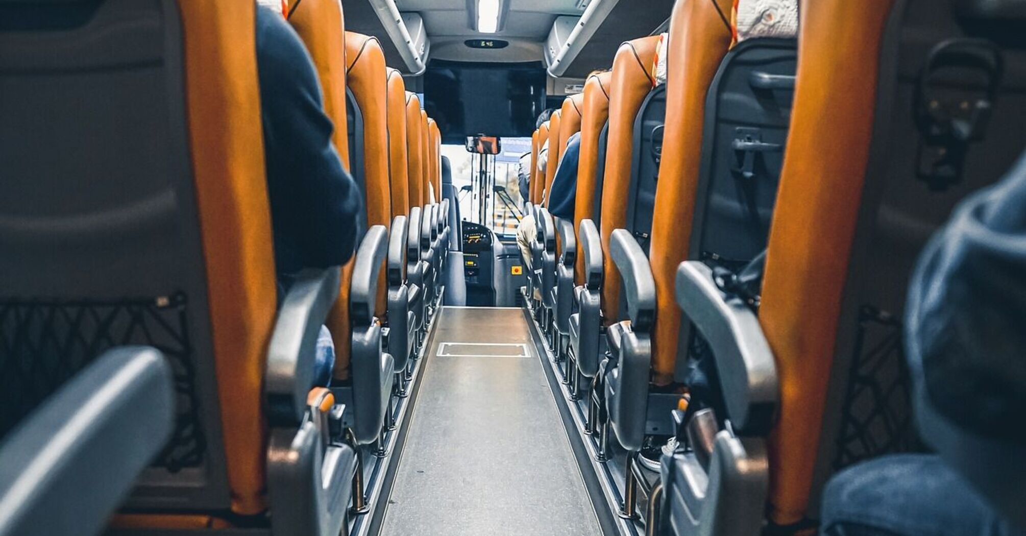 Interior of a modern bus with orange seats