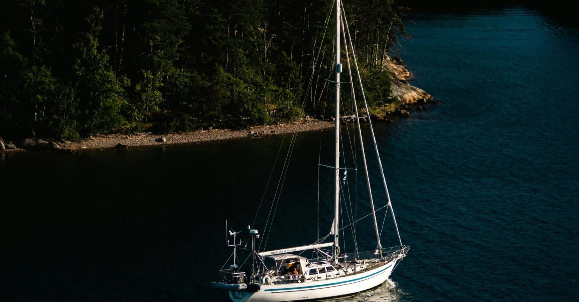 A sailboat moored in a serene archipelago bay