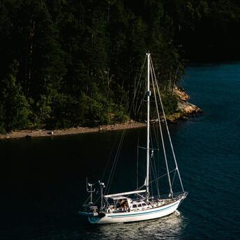 A sailboat moored in a serene archipelago bay