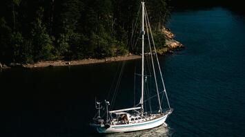A sailboat moored in a serene archipelago bay