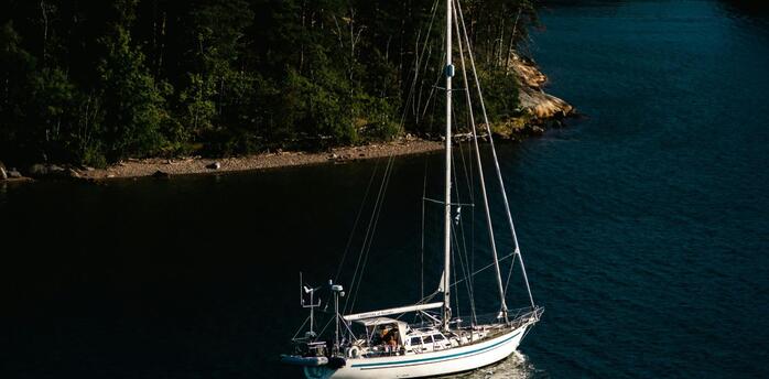 A sailboat moored in a serene archipelago bay