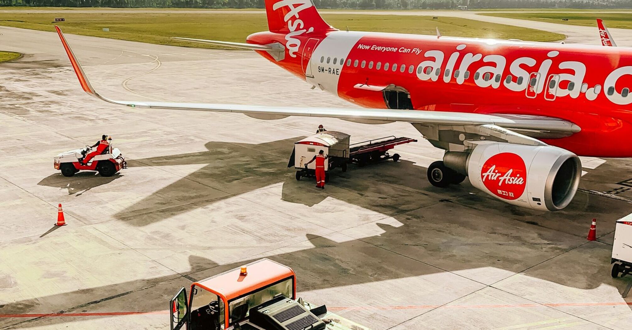 AirAsia aircraft on the tarmac at an airport with ground services