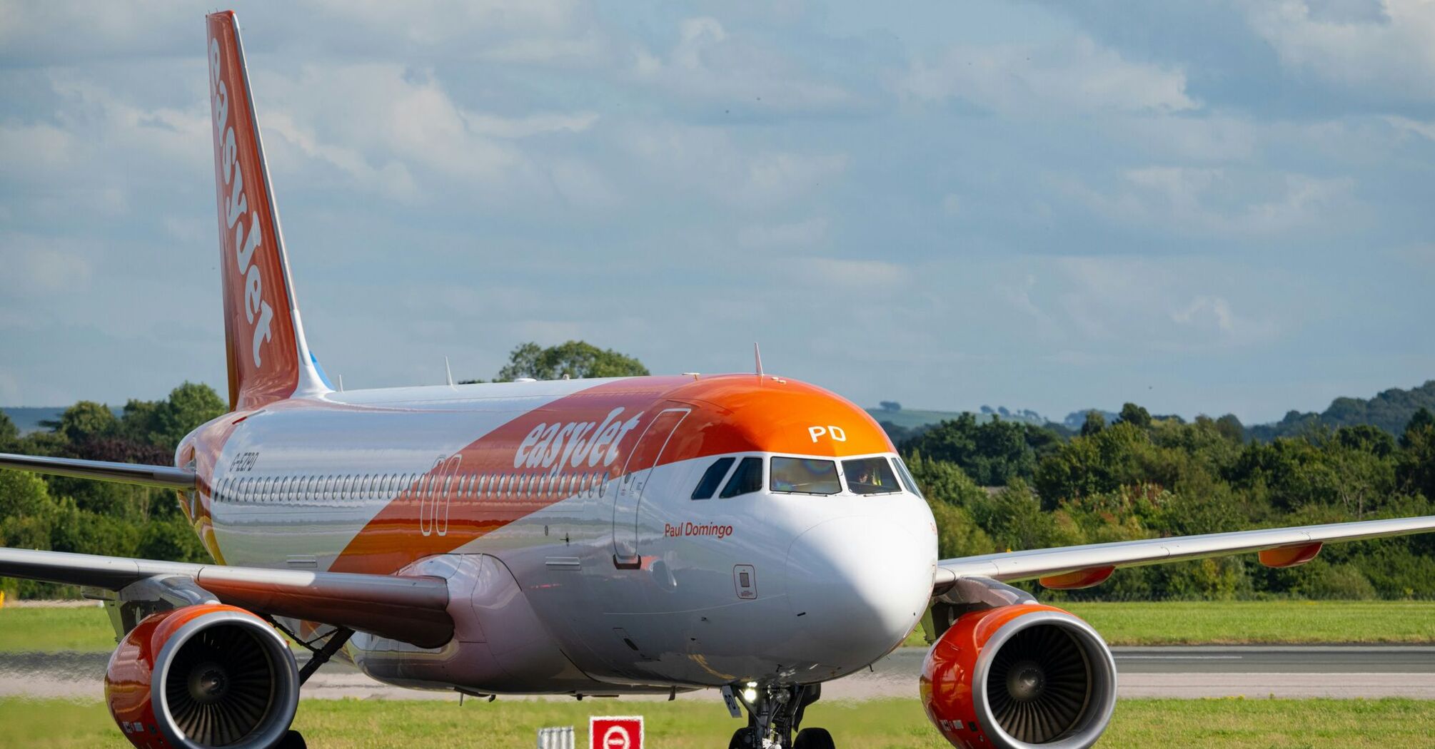 an orange and white airplane is on the runway