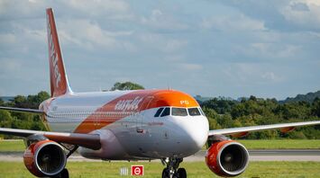an orange and white airplane is on the runway