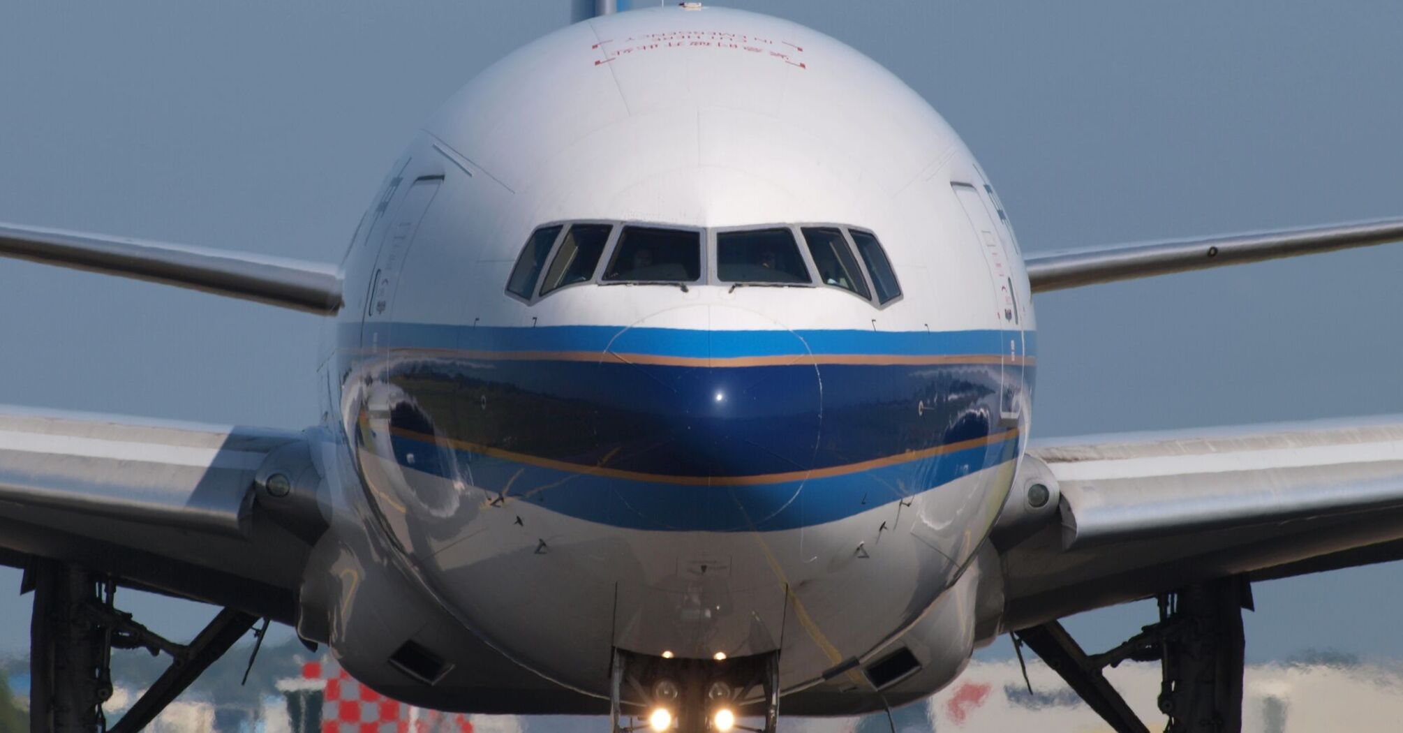 Front view of a large commercial airplane on the runway