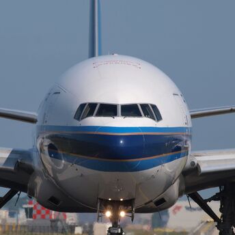 Front view of a large commercial airplane on the runway