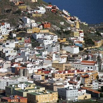 A densely packed residential area on a hillside in the Canary Islands