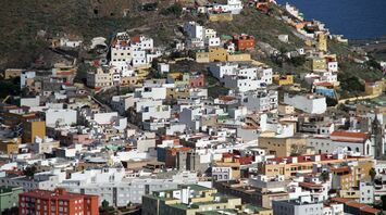 A densely packed residential area on a hillside in the Canary Islands