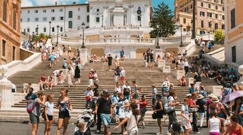 Tourists gathered at the famous Spanish Steps in Rome on a sunny day, enjoying the historical site