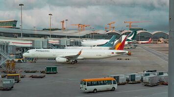 Philippine Airlines aircraft parked at the terminal with other international planes in view at an airport