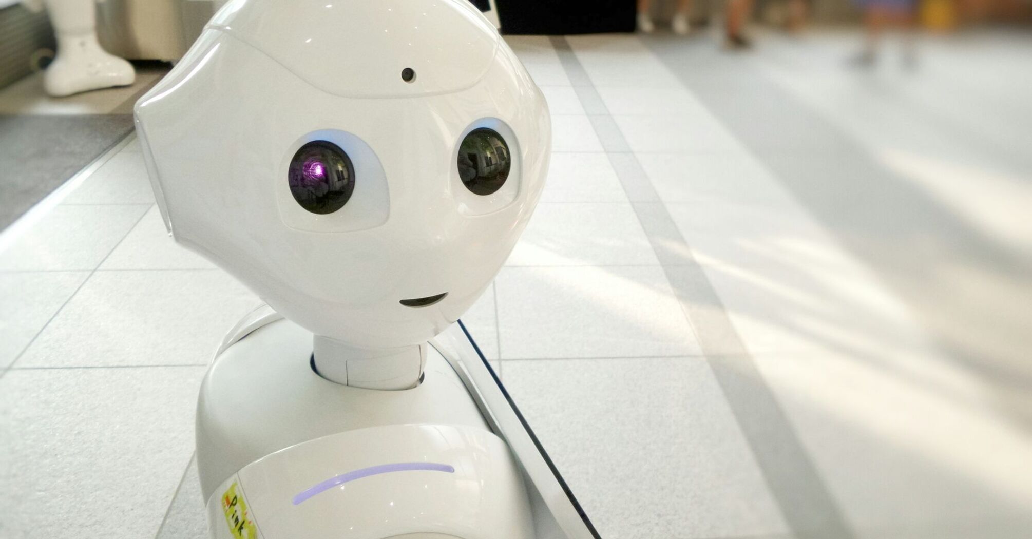 Autonomous AI assistant robot standing in an indoor public space