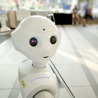 Autonomous AI assistant robot standing in an indoor public space