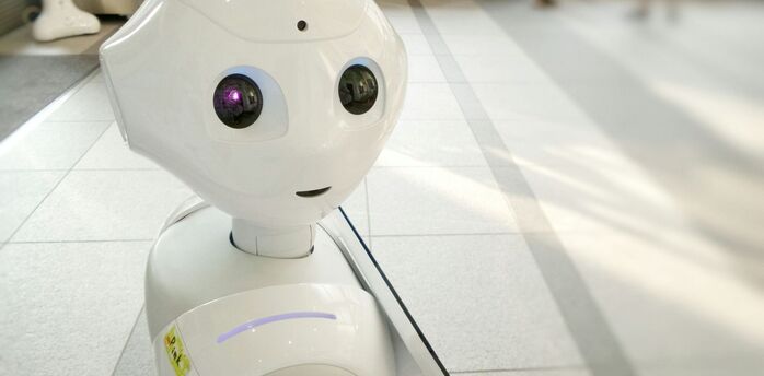 Autonomous AI assistant robot standing in an indoor public space
