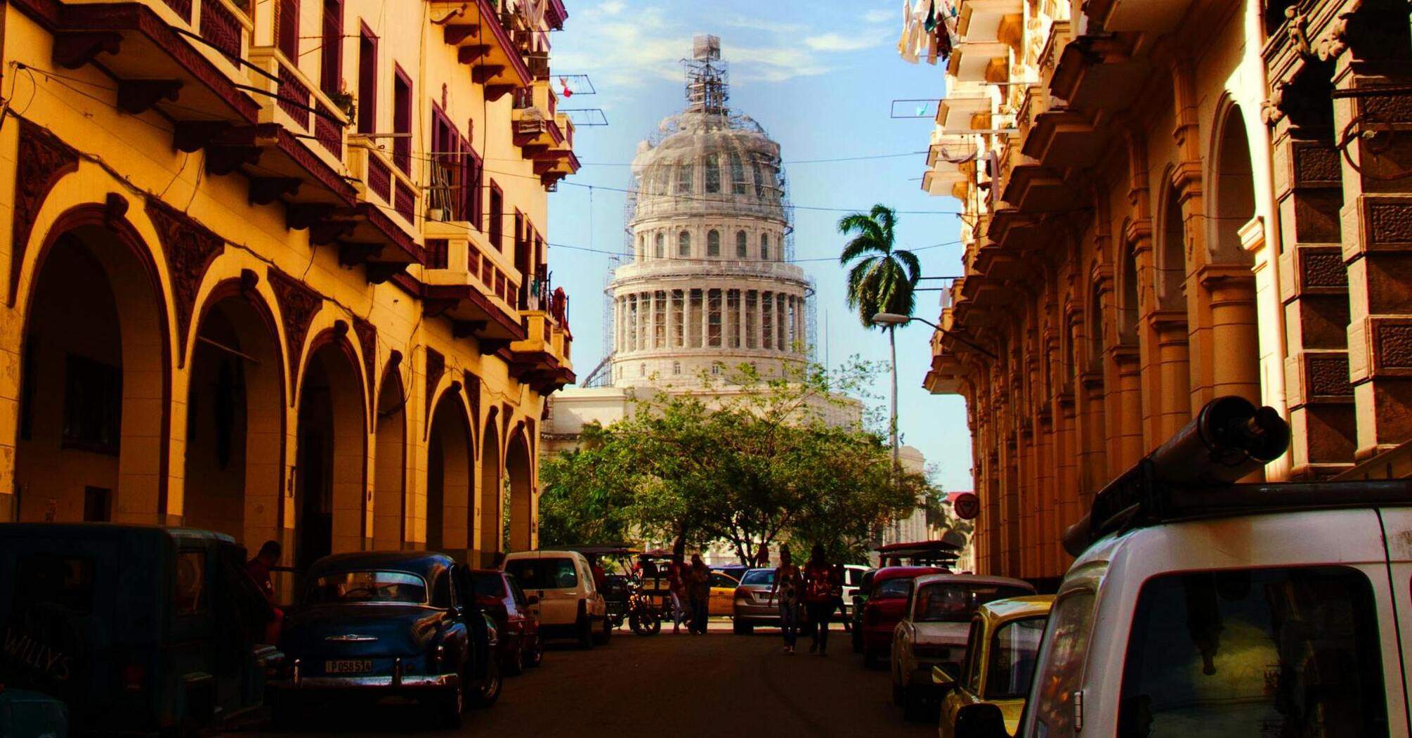 View of Havana street with classic cars and the Capitol building in the background