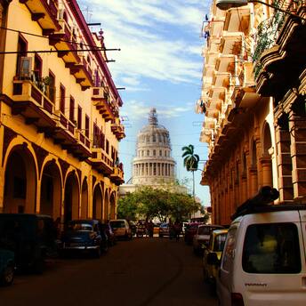 View of Havana street with classic cars and the Capitol building in the background