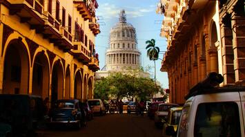 View of Havana street with classic cars and the Capitol building in the background