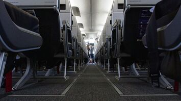The interior of an Avelo Airlines airplane showing rows of seats with a central aisle