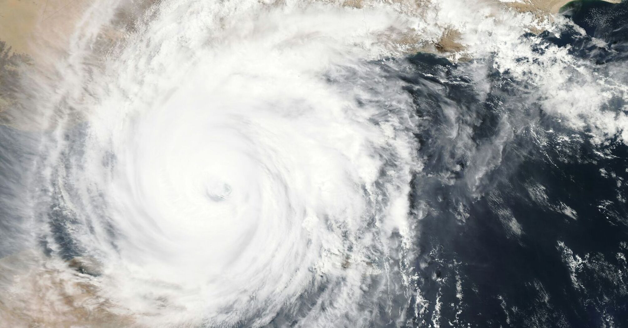 Satellite image of a large typhoon swirling over land and sea