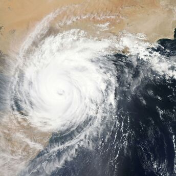 Satellite image of a large typhoon swirling over land and sea