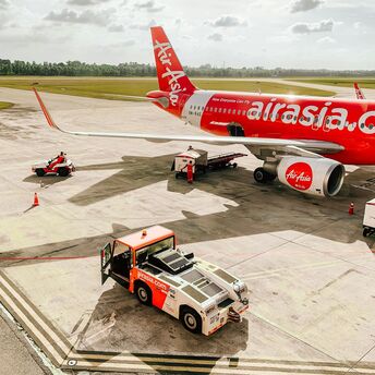 AirAsia aircraft preparing for departure on the tarmac at an airport