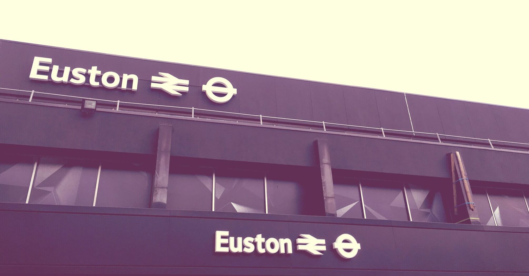 Euston Station building sign with train and London Underground symbols