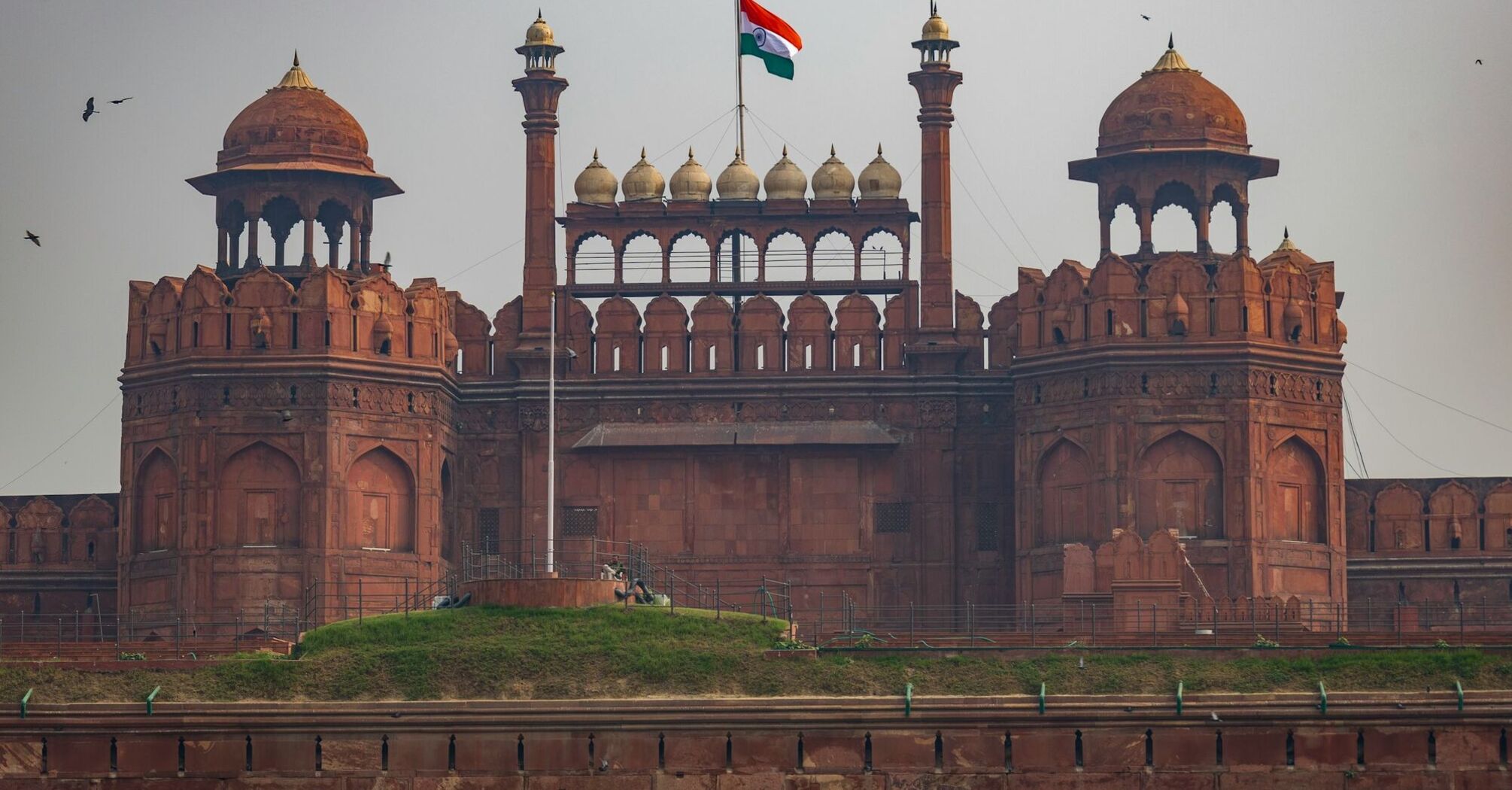 A close-up view of the Red Fort in Delhi, India, with the Indian flag flying atop the historic structure