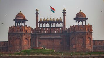 A close-up view of the Red Fort in Delhi, India, with the Indian flag flying atop the historic structure