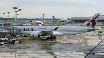 Qatar Airways airplane at airport terminal gate