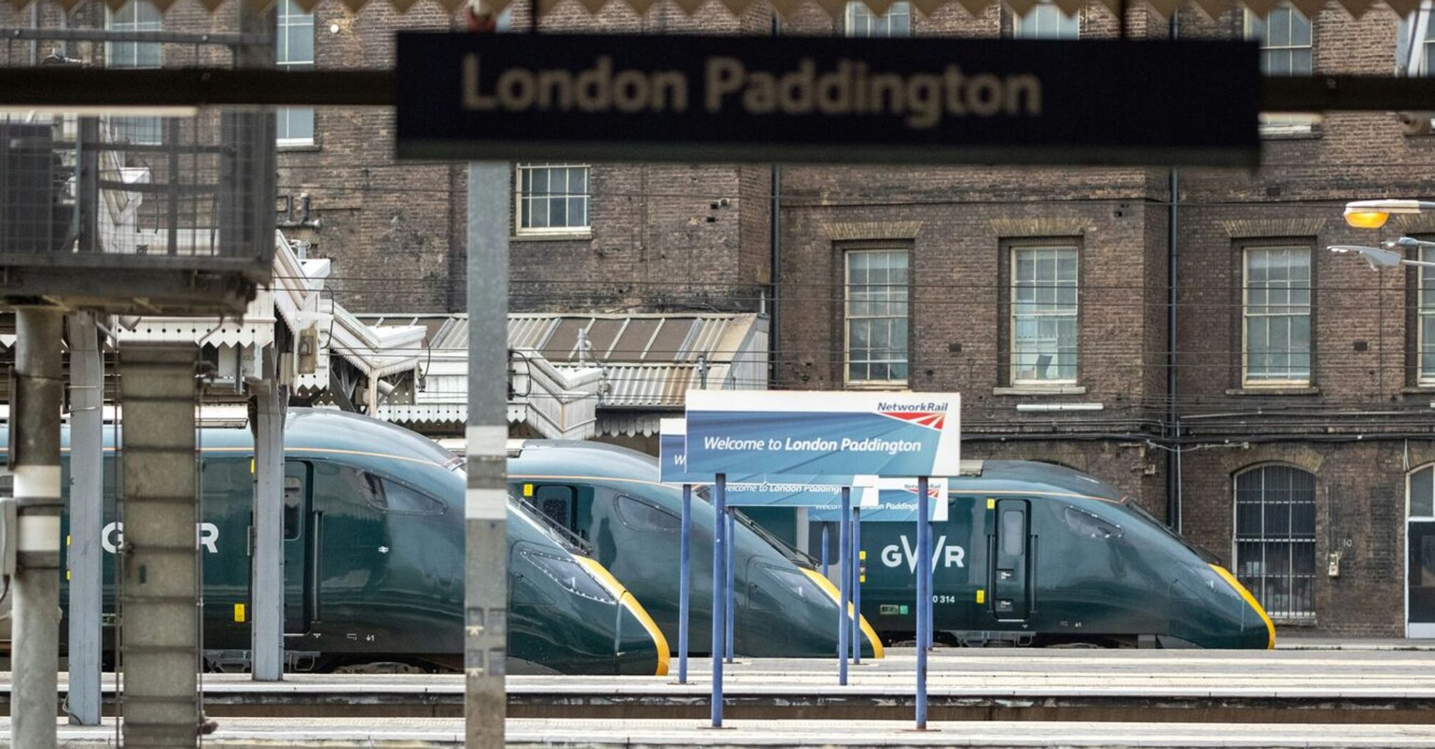 London Paddington train station platform with Great Western Railway trains in the background