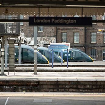 London Paddington train station platform with Great Western Railway trains in the background