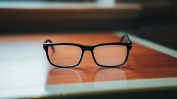 Black glasses on a wooden table