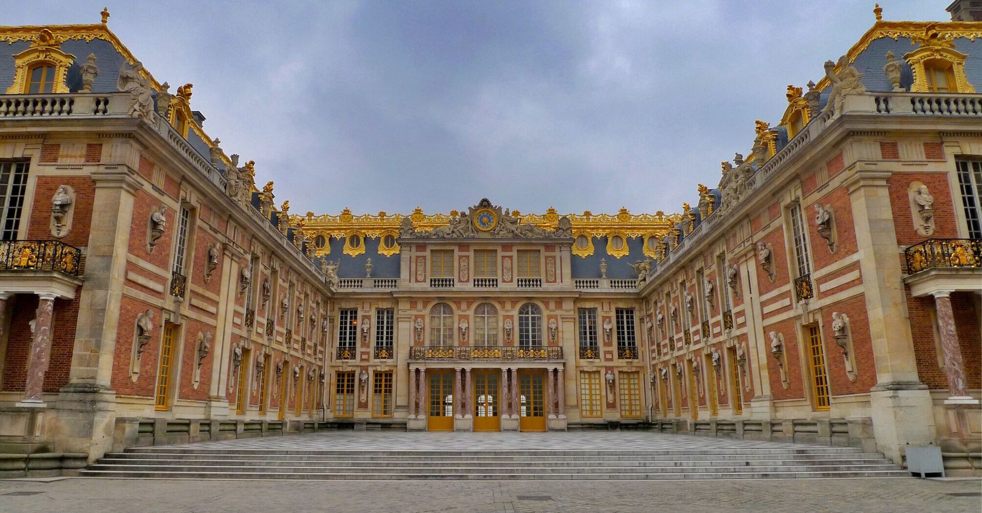 Palace of Versailles courtyard with ornate golden details