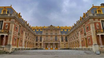 Palace of Versailles courtyard with ornate golden details