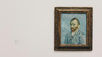 Van Gogh's self-portrait hanging on a museum wall