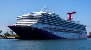 A large cruise ship docked at a sunny port
