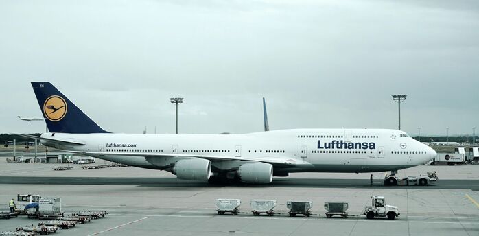 A Lufthansa aircraft at an airport gate, ready for departure