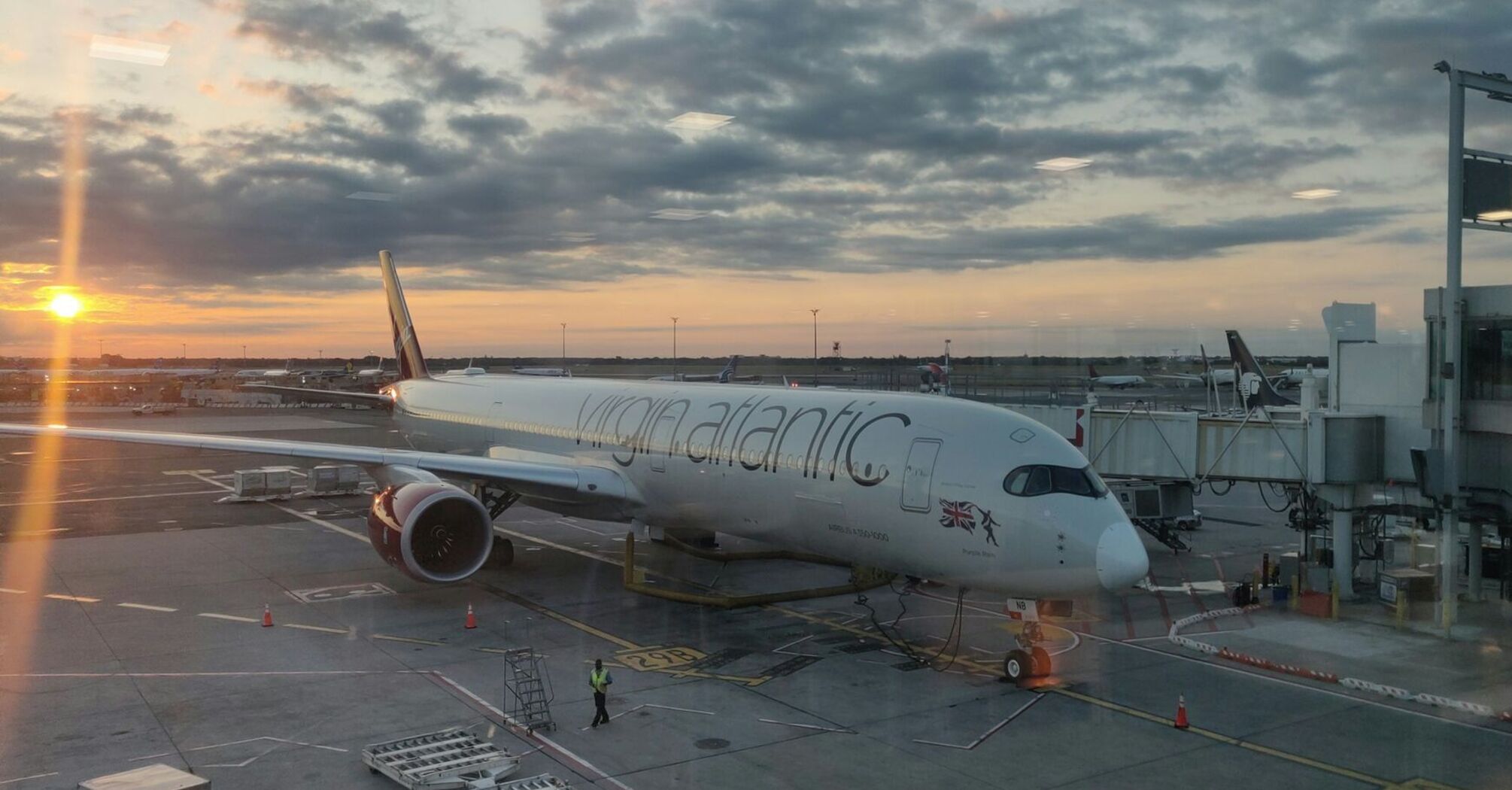 Virgin Atlantic plane parked at the gate during sunset