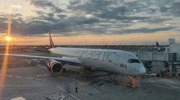 Virgin Atlantic plane parked at the gate during sunset
