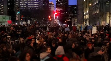 Large crowd protesting in a city at night