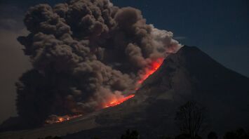 Volcano eruption with ash and lava flow at night