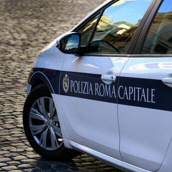 Rome traffic police car on cobblestone street