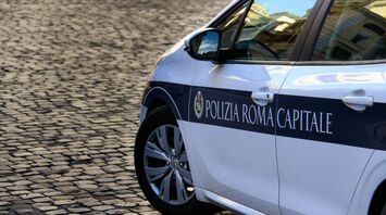 Rome traffic police car on cobblestone street